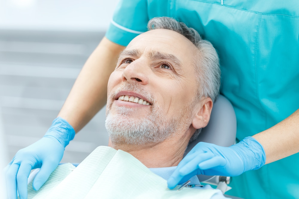 Cropped,Shot,Of,Smiling,Mature,Patient,And,Dentist,In,Medical 1765403617 b8581d2f66754880aaf5b4784186b715 1